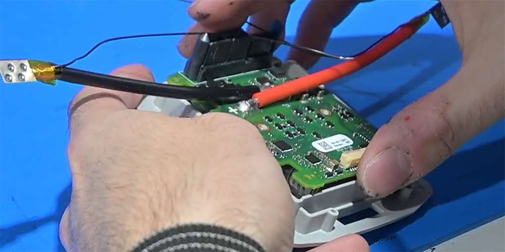A printed circuit board being attached to a chassis.