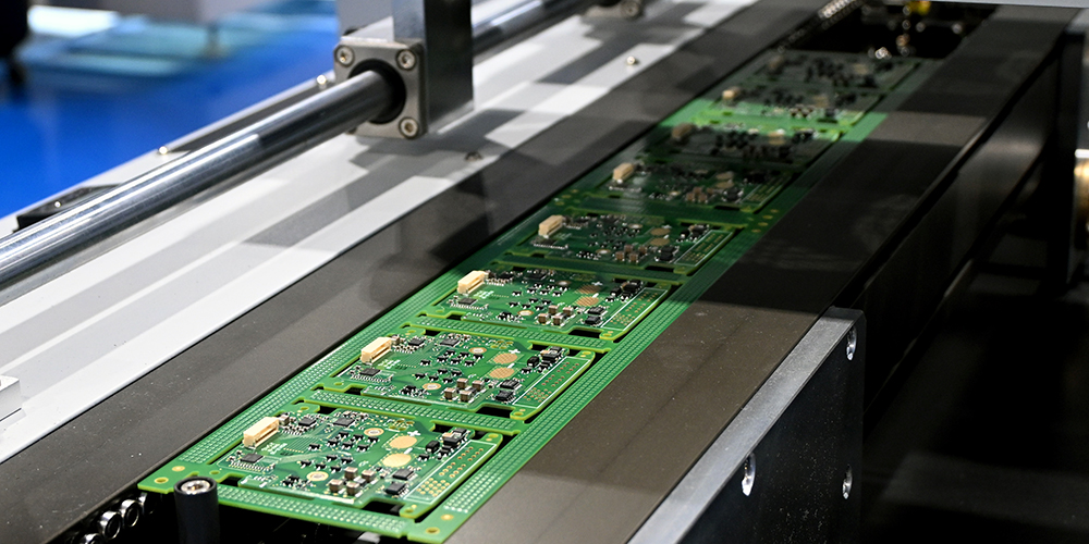 Printed circuit boards on a conveyor belt.